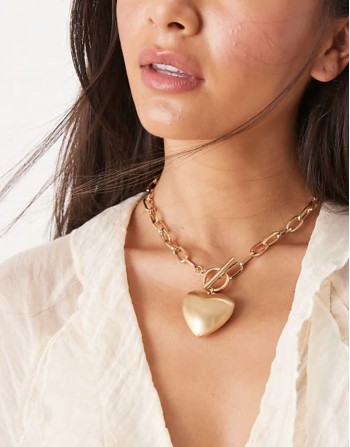 necklace with t-bar and puff heart charm detail in gold tone